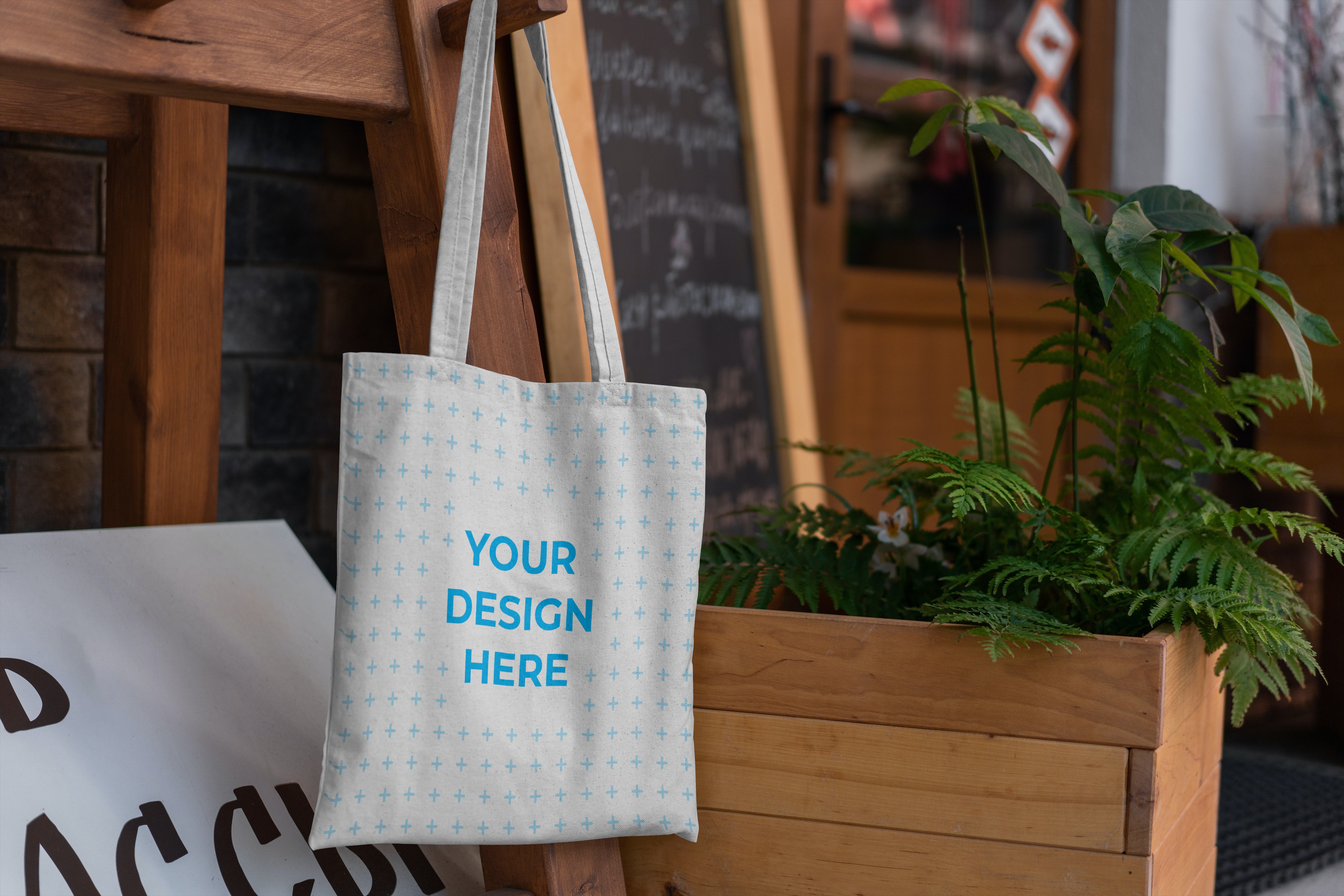 Free Tote bag hanging on a chair Mockup generator